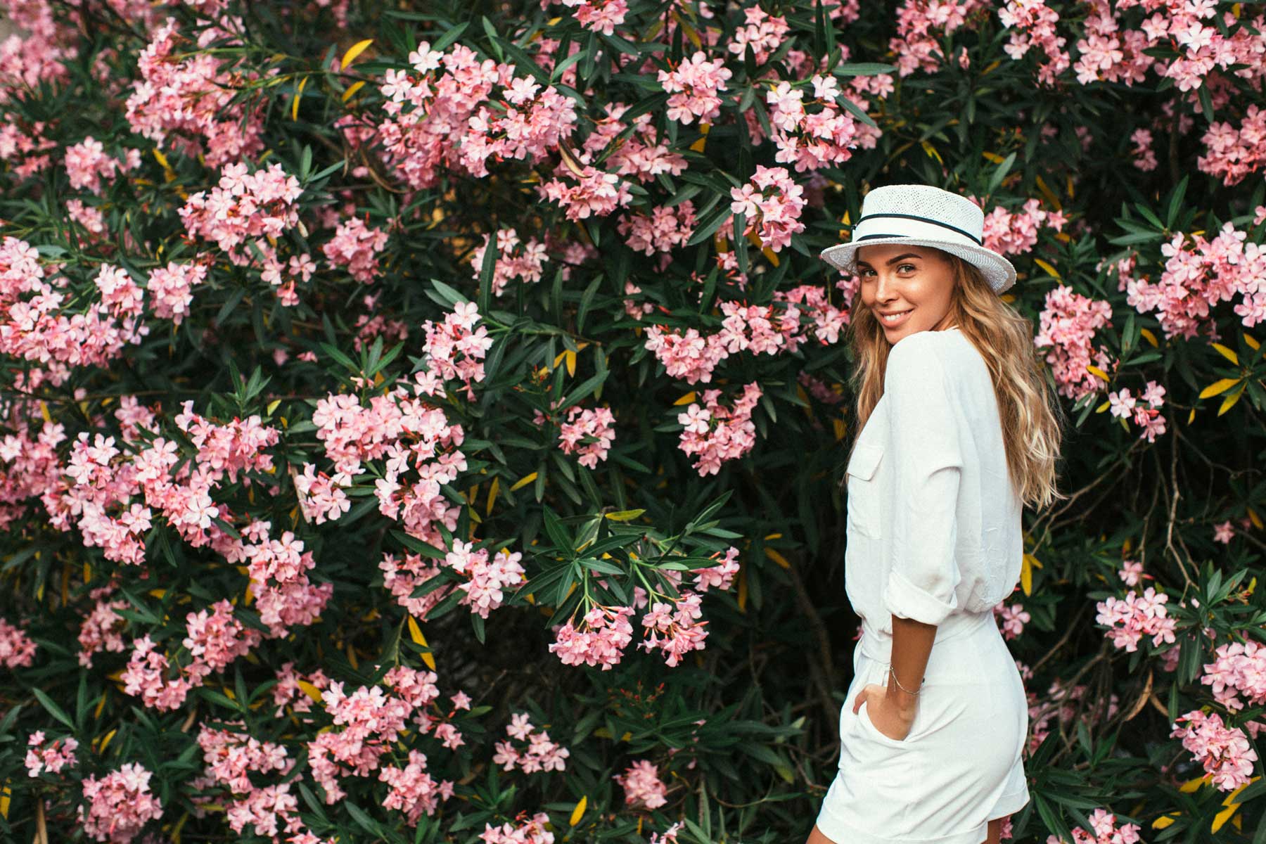 Beautiful girl on the background of spring bush